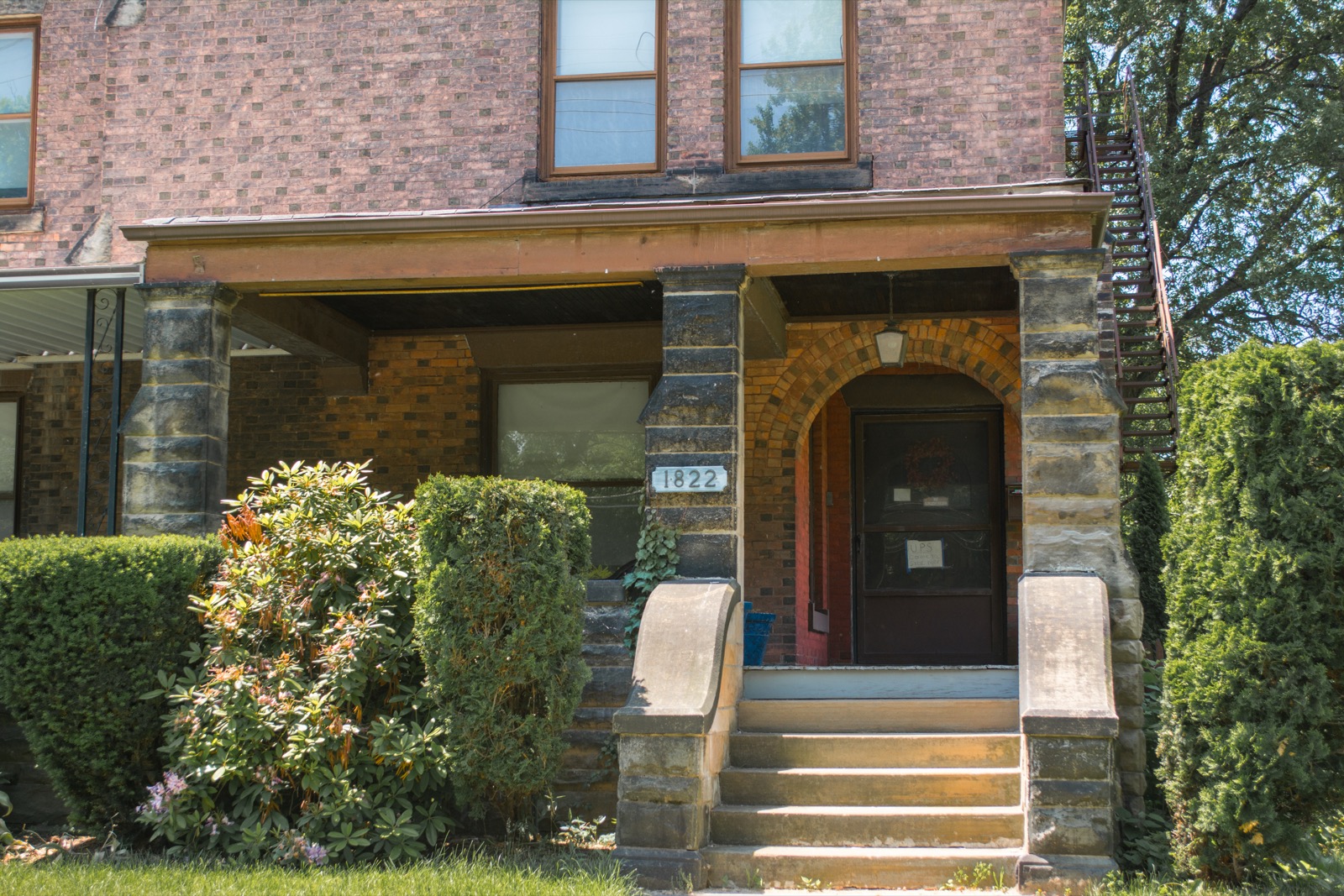 A house entrance with a covered porch and visible steps