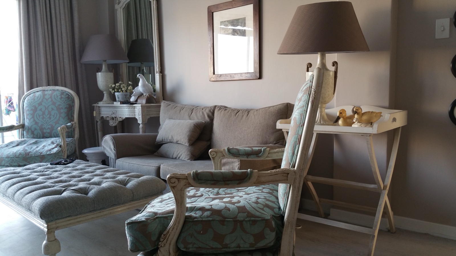 A furnished living room with seating, a table, and everyday objects