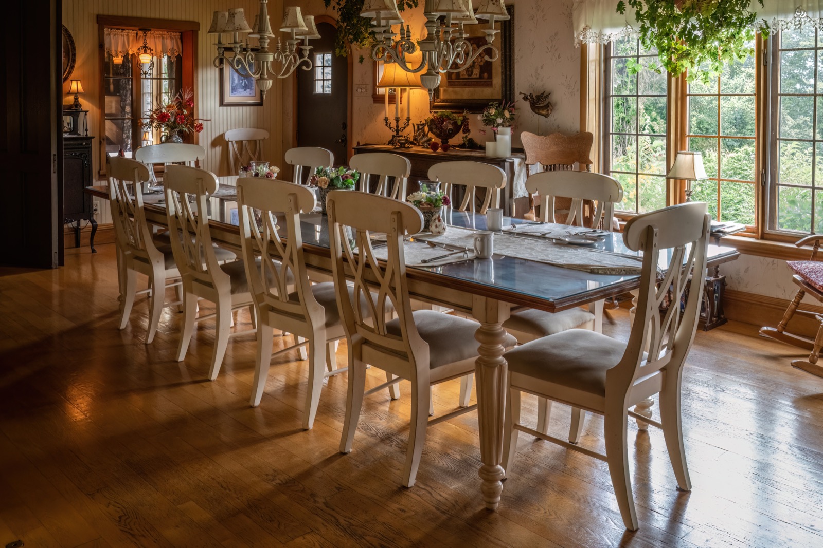 A dining room with tables and chairs arranged for guests